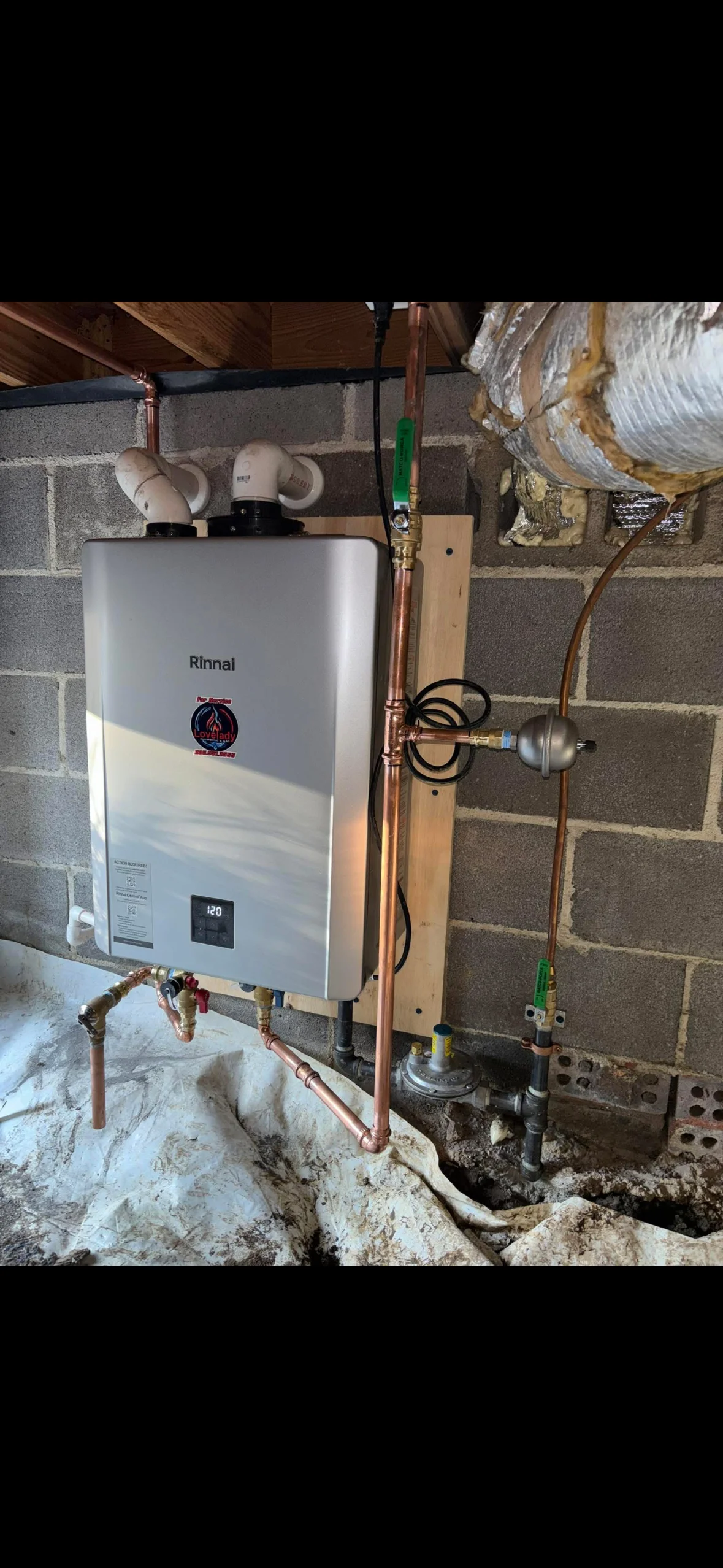 Technician installing a tankless water heater in a residential home