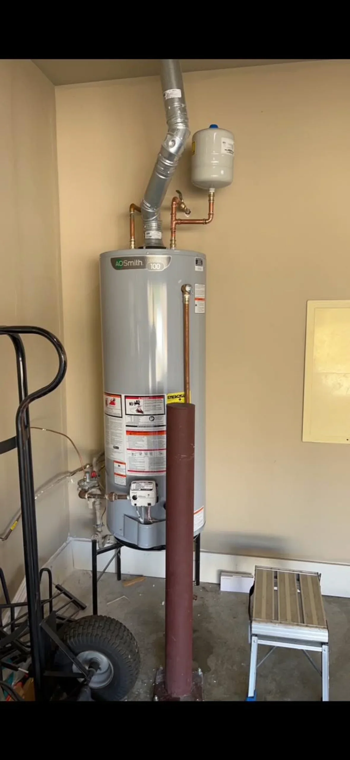 AO Smith water heater with expansion tank, copper piping, and insulated vent ductwork