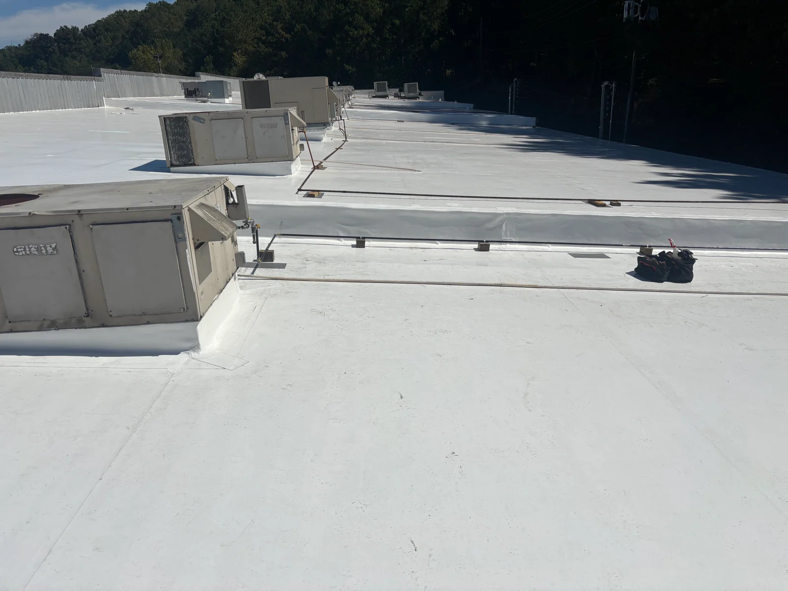 Commercial rooftop with installed gas piping, support brackets, and HVAC equipment connections